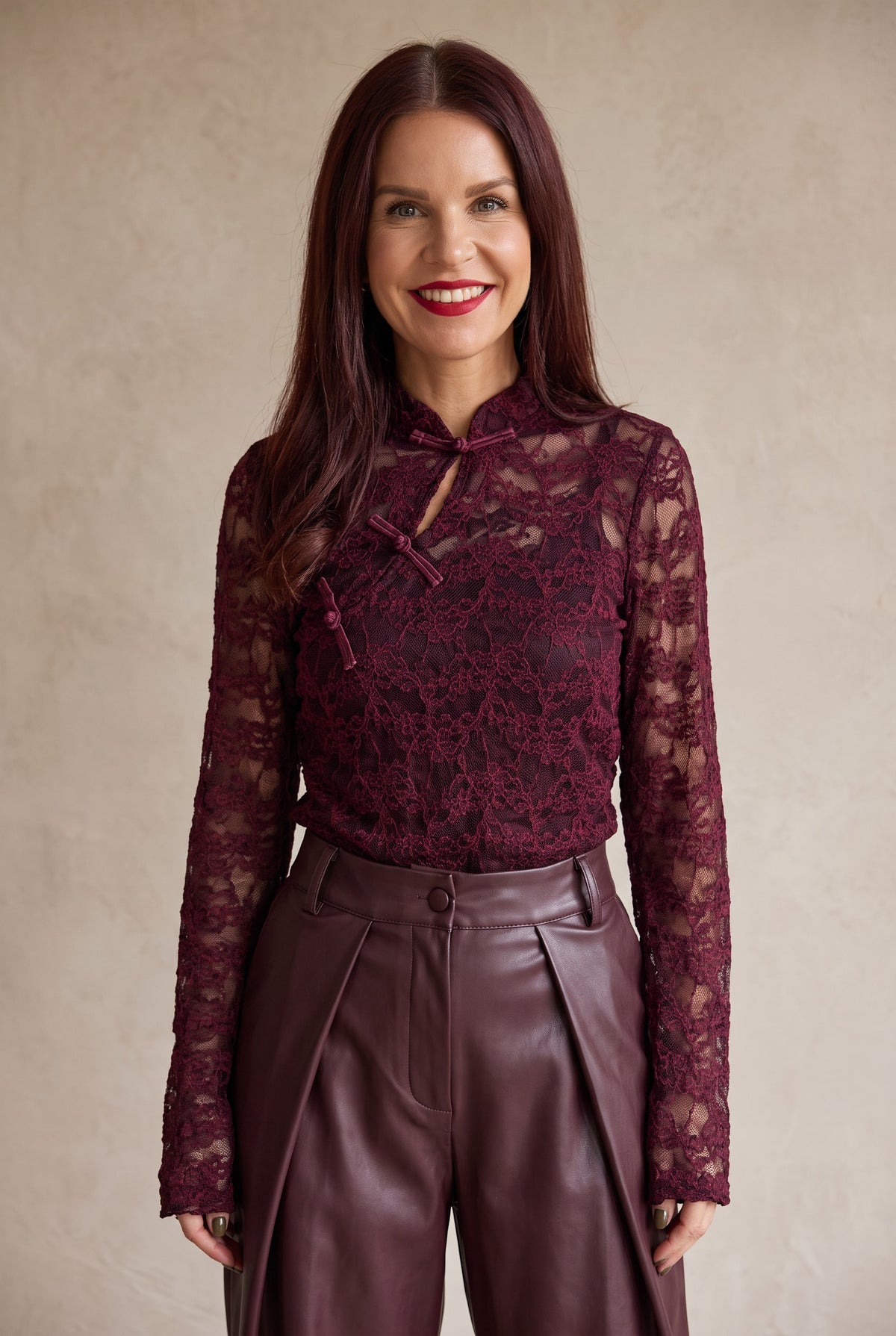 Bob & Bill bordeaux lace long-sleeve top with mandarin collar and keyhole detail worn by a smiling woman