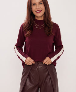 Bob & Bill Vanny bordeaux turtleneck top with white sleeve stripes worn by a woman with dark hair