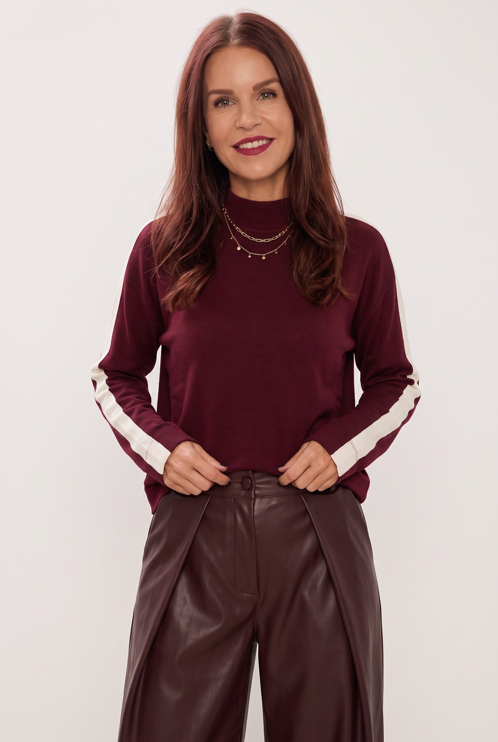Bob & Bill Vanny bordeaux turtleneck top with white sleeve stripes worn by a woman with dark hair