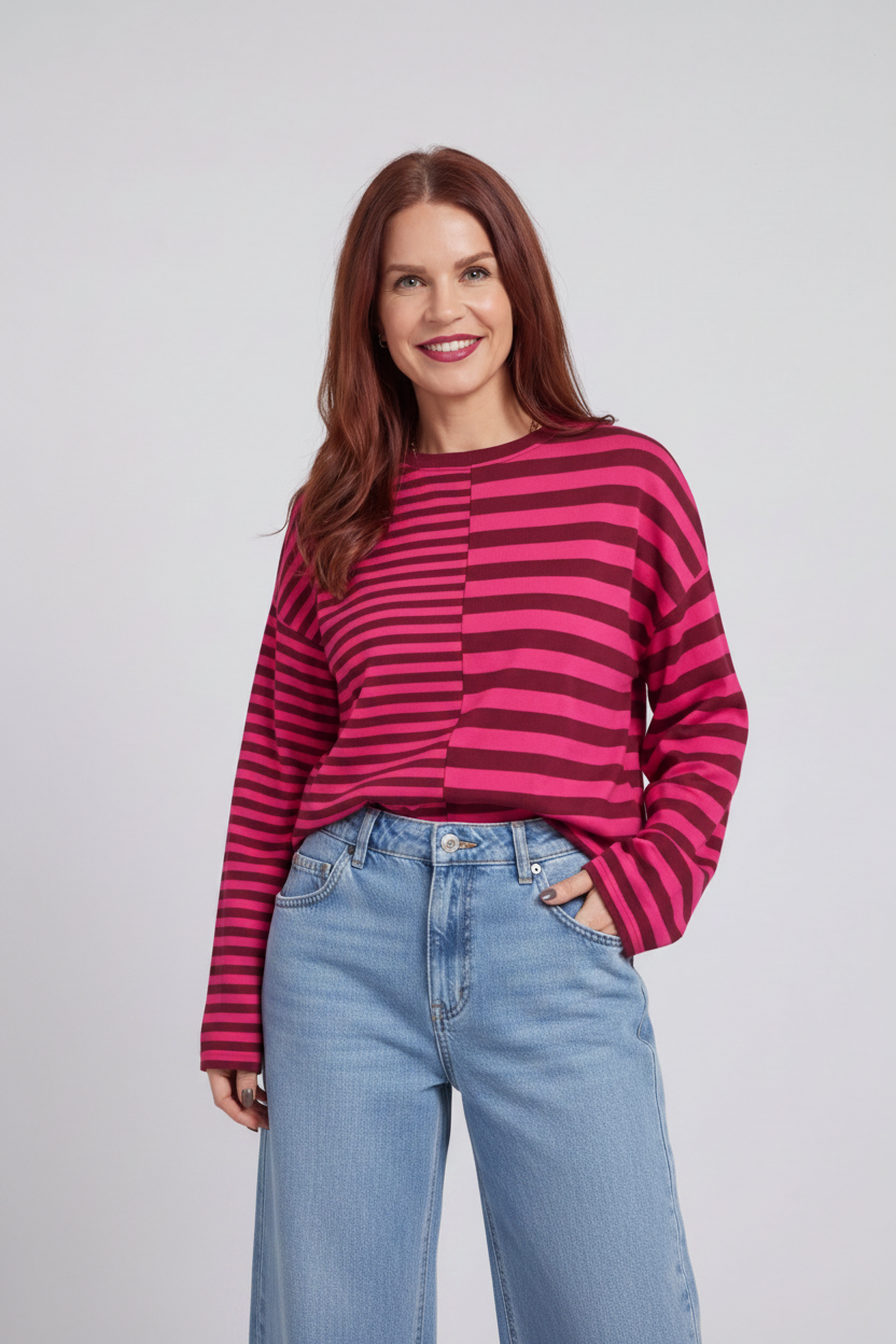 Model wearing a Bob & Bill fuchsia and dark pink striped long-sleeve knit shirt with a relaxed fit and round neck.
