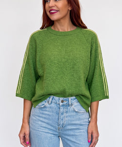 Bob & Bill green knit sweater with yellow shoulder stripes, round neck, and short wide sleeves on a female model