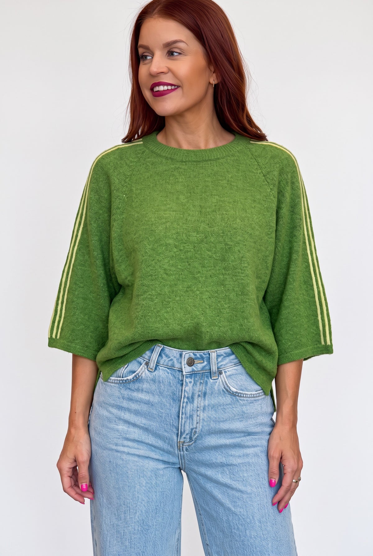 Bob & Bill green knit sweater with yellow shoulder stripes, round neck, and short wide sleeves on a female model