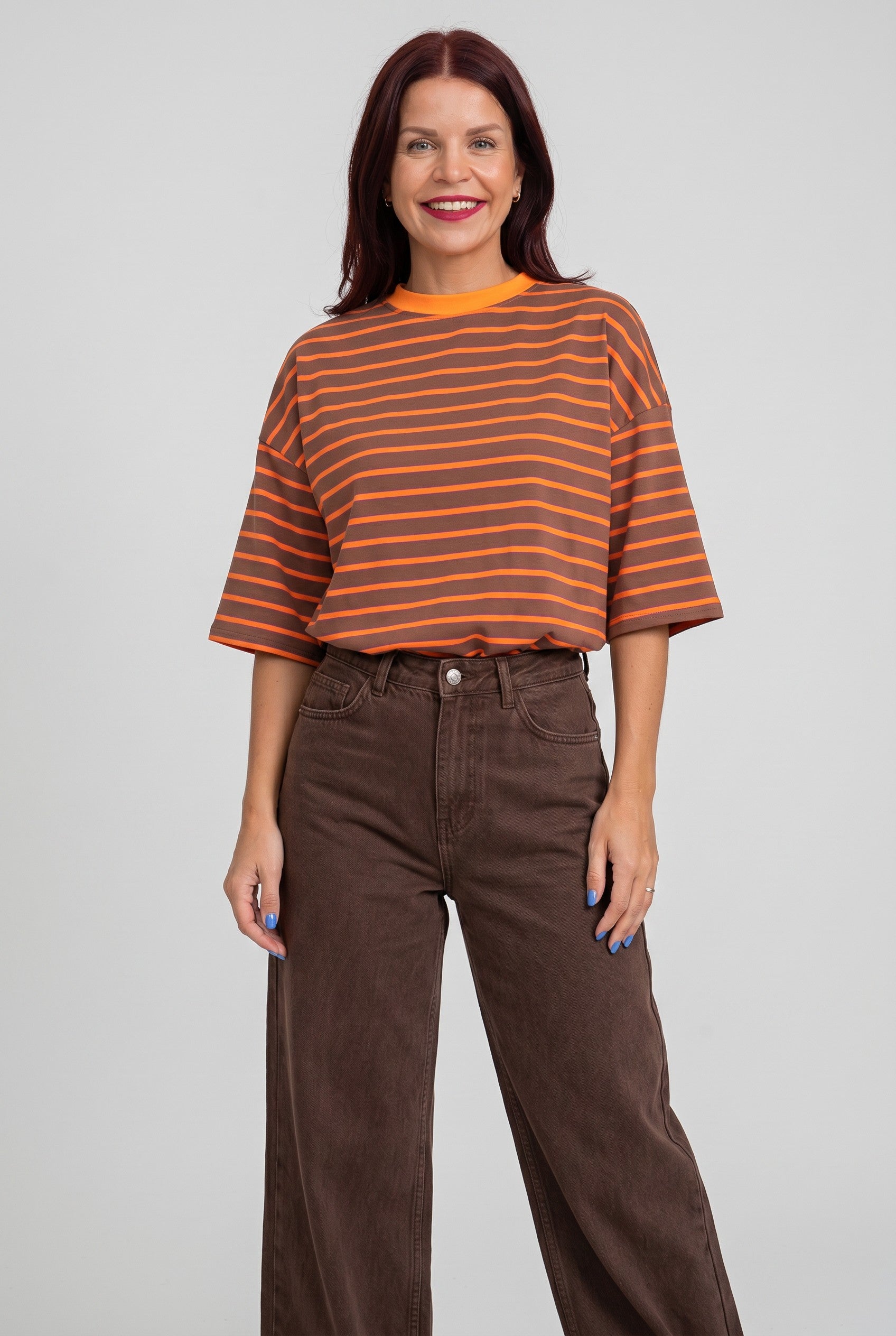 Model draagt Bob & Bill Lulu gestreept T-shirt in oranje en bruin met ronde hals en relaxte pasvorm