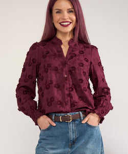 Bob & Bill Nümph Lenea shirt in fig purple cotton with 3D floral embroidery, ruched collar, and smocked cuffs.