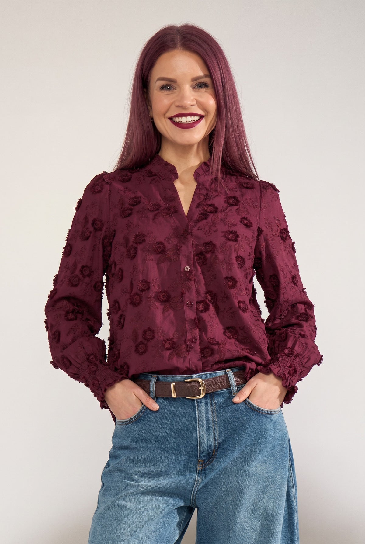 Bob & Bill Nümph Lenea shirt in fig purple cotton with 3D floral embroidery, ruched collar, and smocked cuffs.