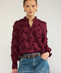 Bob & Bill NÜMPH Lenea shirt in fig purple cotton with 3D floral embroidery, ruched collar, and long cuffed sleeves.