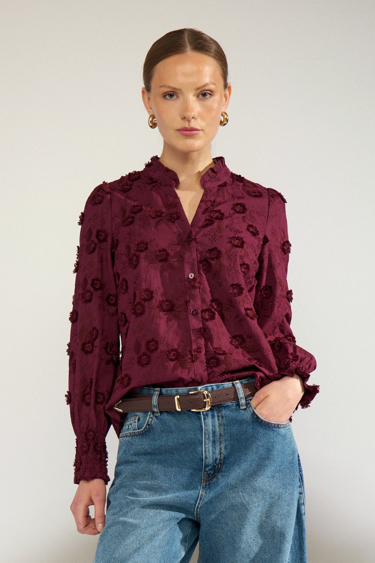 Bob & Bill NÜMPH Lenea shirt in fig purple cotton with 3D floral embroidery, ruched collar, and long cuffed sleeves.