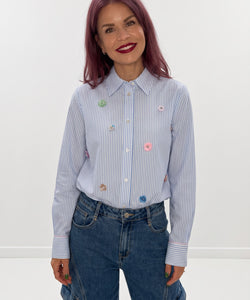 Bob & Bill NÜMPH Lili blue striped shirt with colourful sequin floral details worn by a woman with pink hair