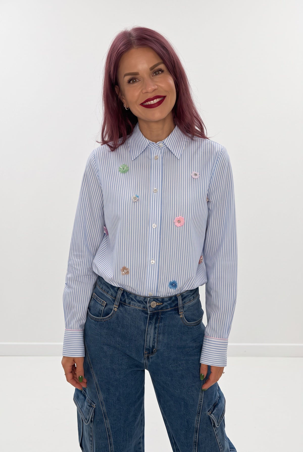 Bob & Bill NÜMPH Lili blue striped shirt with colourful sequin floral details worn by a woman with pink hair