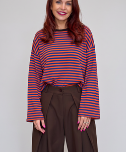 Bob & Bill Sammie long-sleeve knit shirt with orange and blue horizontal stripes and a round neck worn by a woman