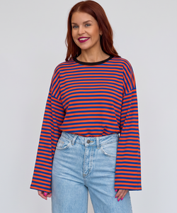 Bob & Bill Sammie long-sleeve knit shirt featuring an orange and blue striped pattern and a round neckline.