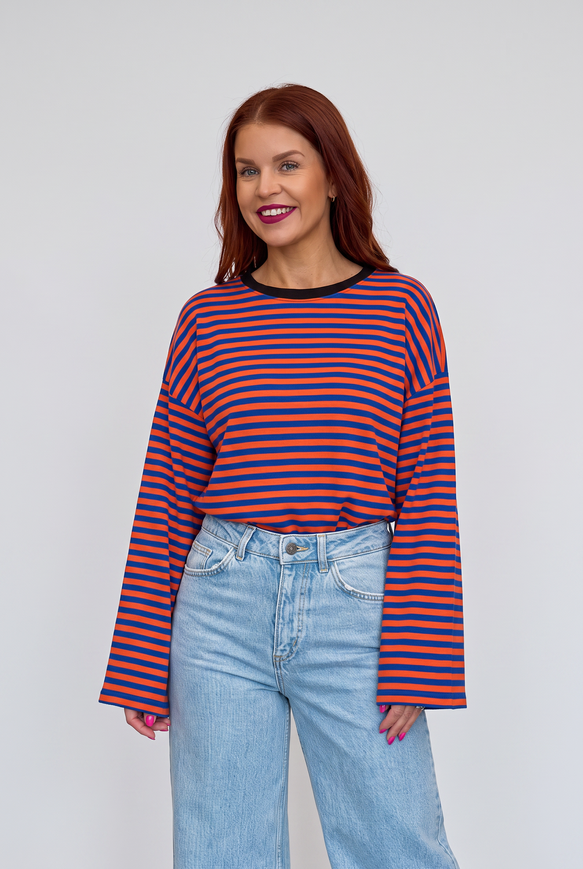 Bob & Bill Sammie long-sleeve knit shirt featuring an orange and blue striped pattern and a round neckline.
