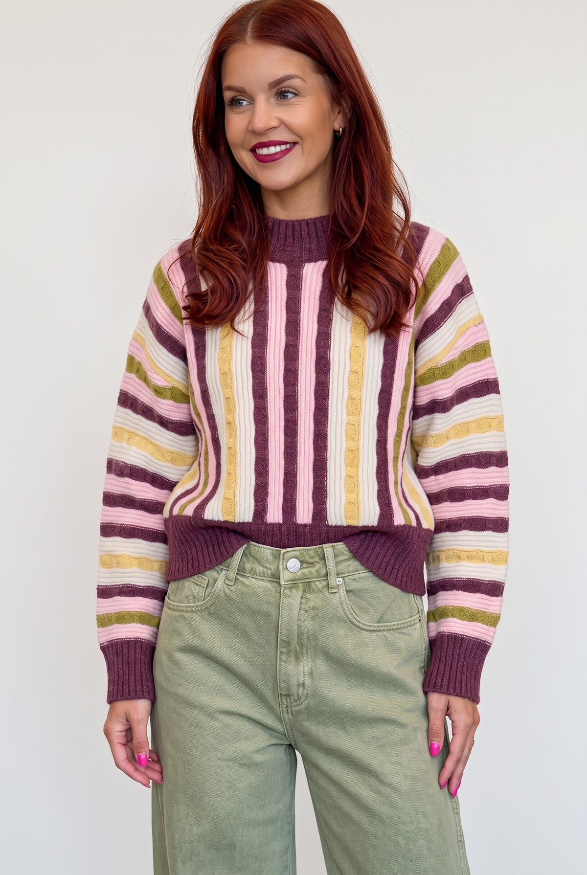 Bob & Bill Sally striped knit sweater in bordeaux, pink, and yellow with ribbed trim worn by a woman